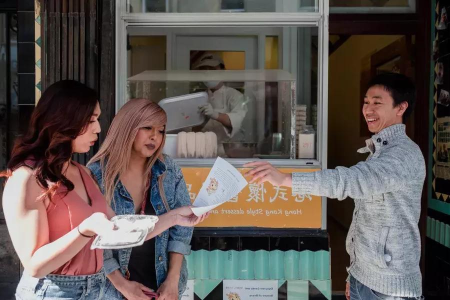 cormack十字架 and friend looking at a menu in Chinatown